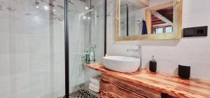 a bathroom with a sink and a glass shower at Quinta de Sito in Chantada +7 photos