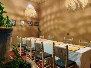 a dining room with a long table and chairs at Dar Talmoudi ,Traditional Riad, Local Food, Camel , Desert Excursions in Tagounite