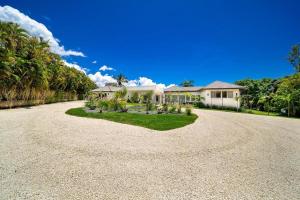 a large house with a gravel driveway at Paradise Villa in La Romana