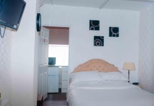 a bedroom with a bed with pictures on the wall at THE CHADWICK in Skegness