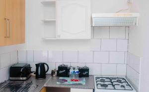 a white tiled kitchen with a stove top oven at THE CHADWICK in Skegness