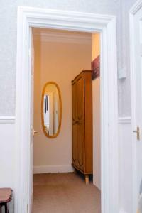a hallway with a mirror and a cabinet in a room at THE CHADWICK in Skegness