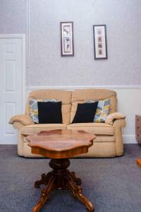 a living room with a couch and a coffee table at THE CHADWICK in Skegness