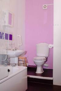 a bathroom with a white toilet and a sink at THE CHADWICK in Skegness