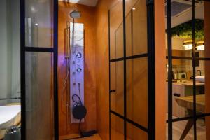 a room with a wooden door and a room with a kitchen at Hidden Garden of Kallithea in Athens