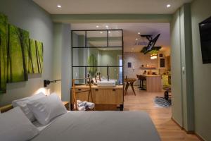 a bedroom with a bed and a bathroom with a sink at Hidden Garden of Kallithea in Athens