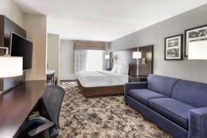 a hotel room with a bed and a couch at Best Western Plus Fairburn Atlanta Southwest in Fairburn