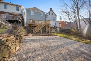 a house with a wooden staircase in a driveway at Classic Pittsburgh 4 Square - Easy Access to Town and Airport in Pittsburgh