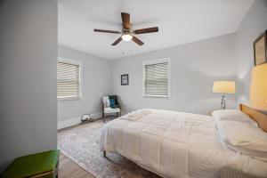a bedroom with a bed and a ceiling fan at Classic Pittsburgh 4 Square - Easy Access to Town and Airport in Pittsburgh