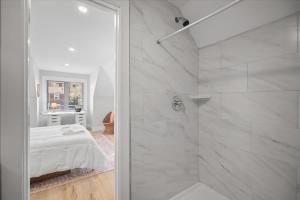 a white bathroom with a shower and a bed at Classic Pittsburgh 4 Square - Easy Access to Town and Airport in Pittsburgh +37 photos