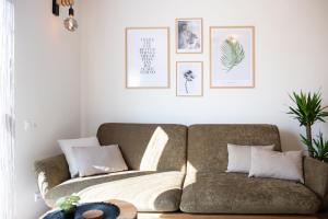 a living room with a couch and pictures on the wall at MH Living - 22 - Scandinavian Living Dream in Center in Graz