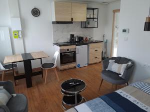 a small kitchen and living room with a table and chairs at 24h course/Moto/ Oasis / Antares in Le Mans