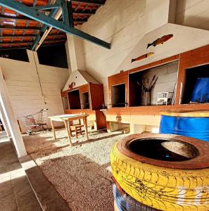 a room with a large tire and a table at Chacara Estrela do Mar in Peruíbe
