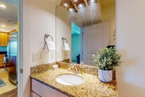 a bathroom with a sink and a mirror at Riverfront Retreat in Seaside +16 photos