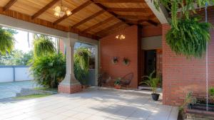 a porch of a brick house with a wooden ceiling at Casa Familiar la Tortuga in Heredia