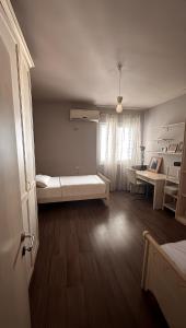 a room with a bed and a desk in it at CozyNest Apartments in Tirana