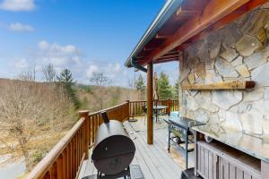 a grill on a deck with a stone wall at Camp Unicorns Bigfoot Manor in Marion