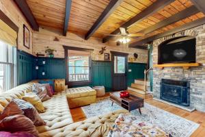 a living room with a couch and a fireplace at Camp Unicorns Bigfoot Manor in Marion