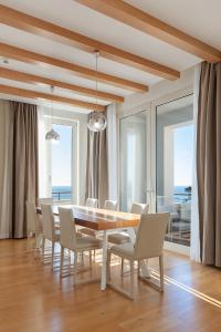 a dining room with a table and chairs at Villa Hedonism in Sveti Stefan