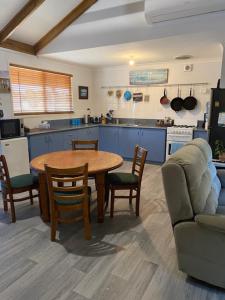 a kitchen with a table and chairs and a couch at Dongara Breeze Inn in Dongara