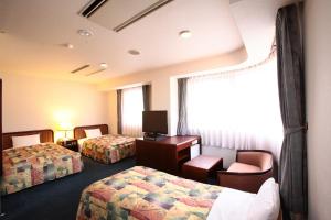 Giường trong phòng chung tại Hotel Ermou Regency