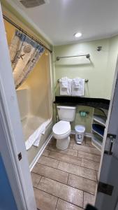a small bathroom with a toilet and a shower at Ocean Front 53 Steps in Myrtle Beach