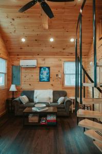 a living room with a couch in a wooden cabin at Mountainscape: Peaceful & Skiing in Roxbury