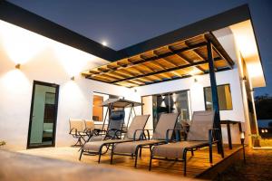 a group of chairs sitting on a deck at New beach house @ Costa del Sol in La Paz