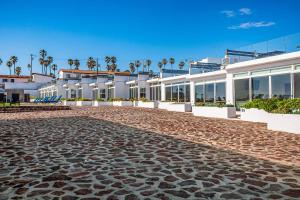 a cobblestone street in front of a building at Casa Blanca 44 - Playa Arcangel in Rosarito