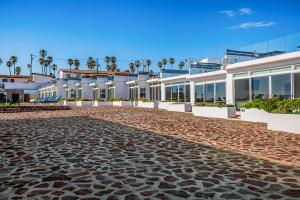a cobblestone street in front of a building at Casa Platino 22 - Playa Arcangel in Rosarito