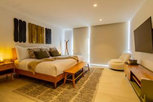 a bedroom with a king sized bed and a flat screen tv at Capitalia - Luxury Apartments - Polanco - Alejandro Dumas in Mexico City