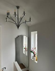a bathroom with a mirror and a chandelier at Double Room- 1 Person -in Great Barr Near M5 - M6 - Parking - TV Bed-Garden in Birmingham