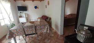 a dining room with a table and chairs in a room at Hospedaje PIEDRA BUENA in Comandante Luis Piedra Buena