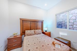 a bedroom with a bed and a window at Casa Terra 38 - Playa Arcangel in Rosarito