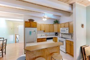 a kitchen with wooden cabinets and a white refrigerator at Take a Peak in Incline Village