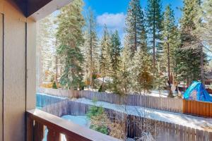 a balcony with a view of the snow covered trees at Take a Peak in Incline Village