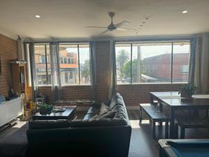 a living room with a couch and a table at The Entrance Backpackers in The Entrance