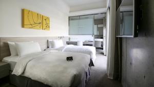 Кровать или кровати в номере CityInn Hotel Plus- Fuxing North Road Branch