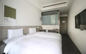 Letto o letti in una camera di CityInn Hotel Plus- Fuxing North Road Branch