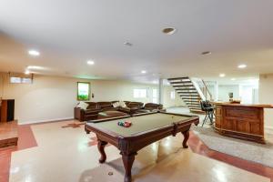 a living room with a pool table and a couch at The 9th Green in Colorado Springs