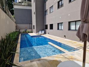 a swimming pool in front of a building at Studio Liberdade in São Paulo