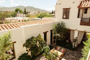 a view of the courtyard of a house with trees at El Cortijo Hotel Boutique in Cachí