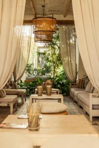 a living room with couches and tables and a chandelier at El Cortijo Hotel Boutique in Cachí +55 photos