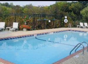 a large swimming pool with chairs and a fence at 4 Seasons Lodge in Gatlinburg