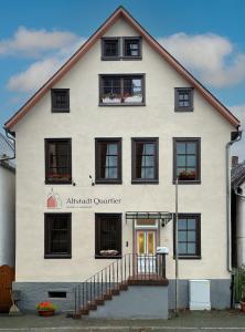 a large white building with black windows at Altstadt Quartier in Schotten