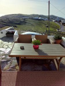 a wooden table sitting on top of a balcony at Anerada sunset in Ano Meria