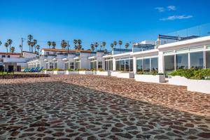 a cobblestone street in front of a building at Villa Olivo 45 - Playa Arcangel in Rosarito