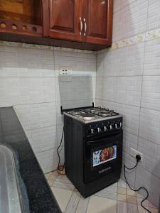 a stove in the corner of a kitchen at HILLS APARTMENTS in Kampala
