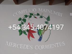 un cartel en una pared con un pájaro. en COMPLEJO MAINUMBI BARRIO Hipotecario, en Mercedes 2 fotos más