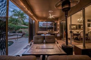 - un salon avec un ventilateur de plafond et une table dans l'établissement Scottsdale Grayhawk Enclosed Sunroom, Outside Relaxing, Pool, Near 10 and Golf Courses & Concierge, à Scottsdale